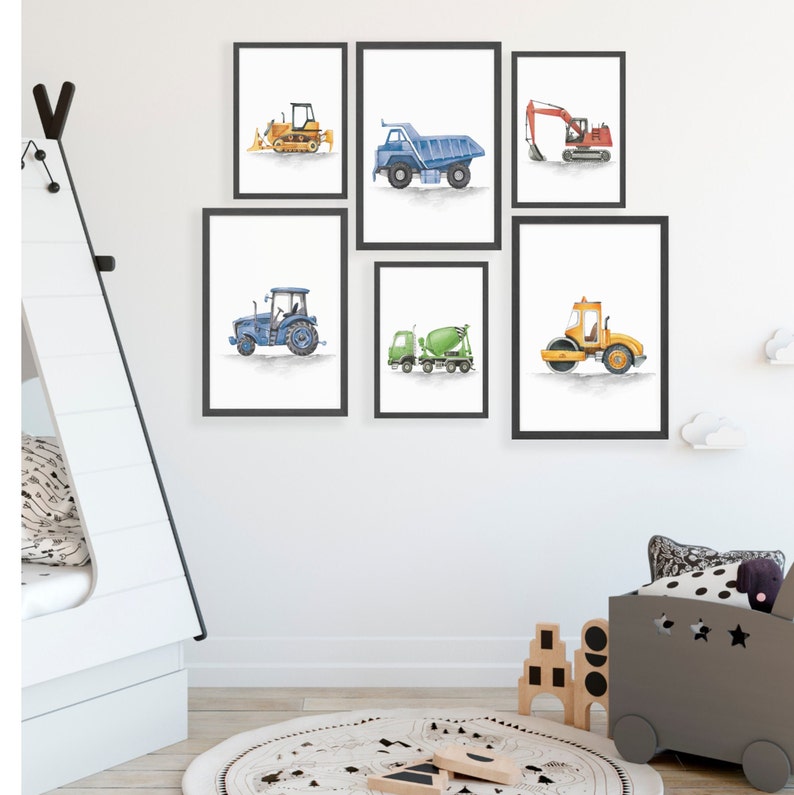 May include: Set of six watercolor illustrations of construction vehicles, including a bulldozer, dump truck, excavator, tractor, cement mixer, and a roller. The illustrations are framed in black frames and hung on a white wall.