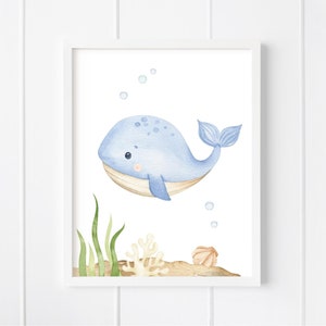 May include: A watercolor illustration of a blue whale with a light brown belly, swimming in the ocean with bubbles. There are green seaweed and a coral reef in the background.
