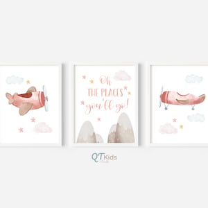 May include: Three watercolor prints featuring a pink airplane with gold accents, clouds, and stars. The middle print has the text "Oh the places you'll go!" in pink.
