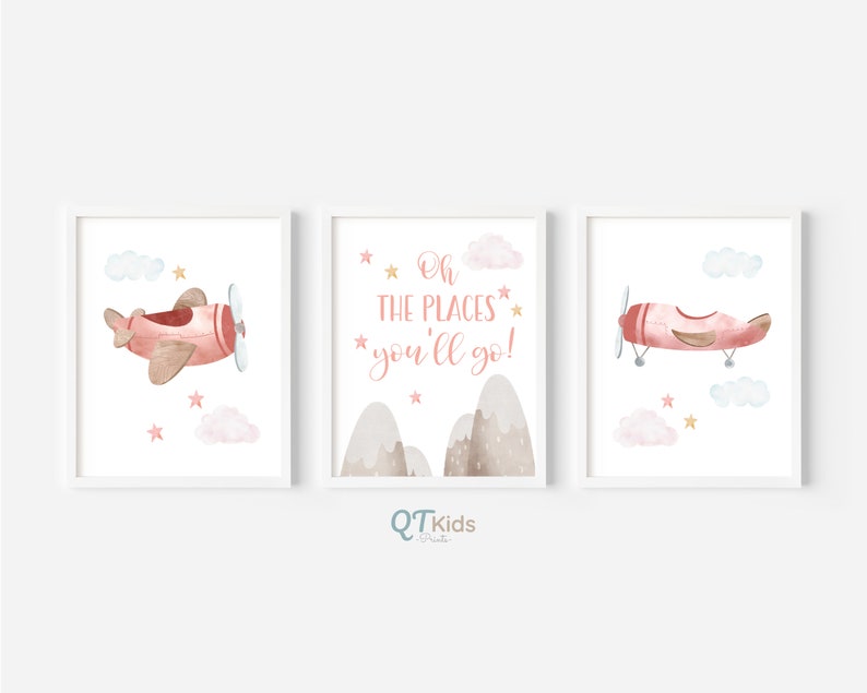 May include: Three watercolor prints featuring a pink airplane with gold accents, clouds, and stars. The middle print has the text "Oh the places you'll go!" in pink.