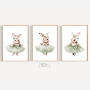 May include: Three framed watercolour prints showcasing charming bunnies in ballet outfits. Each bunny is dressed in a sage green tutu and a floral crown. The artwork has a soft, whimsical style, ideal for a nursery or children's room.