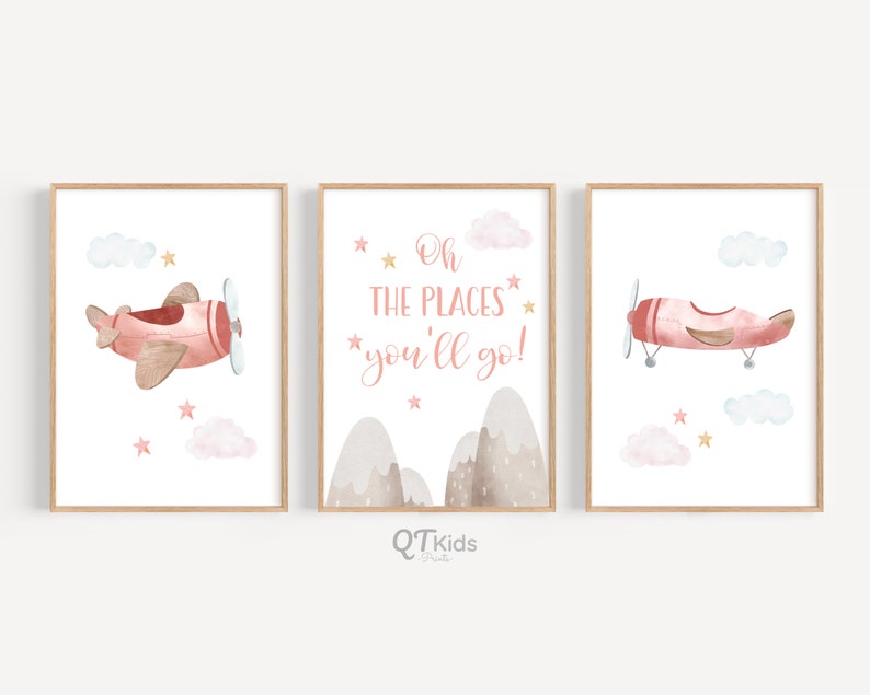 May include: Three watercolor prints featuring a pink airplane flying in a blue sky with white clouds and gold stars. The middle print has the text "Oh the places you'll go!" in pink lettering.