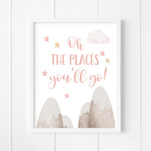 May include: A pink and gold nursery print with the text "Oh the places you'll go!" with a cloud and mountains in the background.