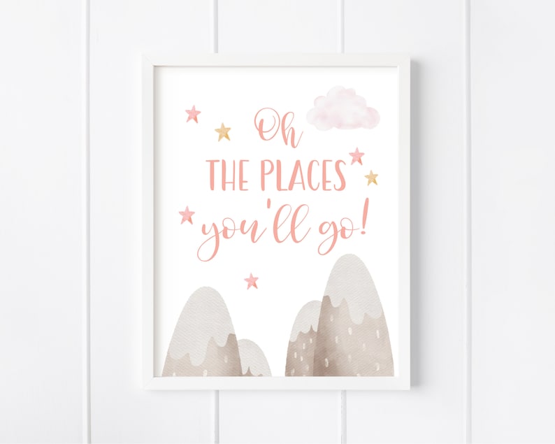 May include: A pink and gold nursery print with the text "Oh the places you'll go!" with a cloud and mountains in the background.