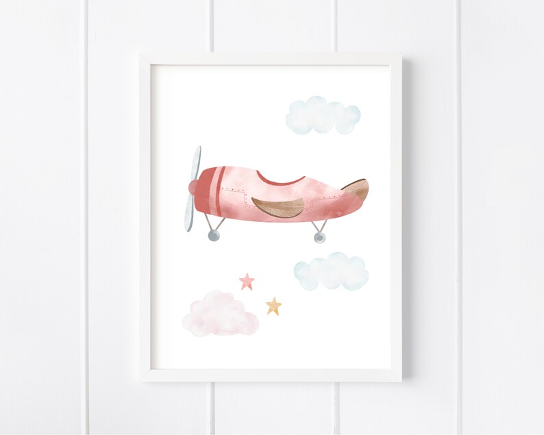 May include: A watercolor illustration of a pink airplane flying in the sky with clouds and stars. The airplane has a brown propeller and a brown tail.