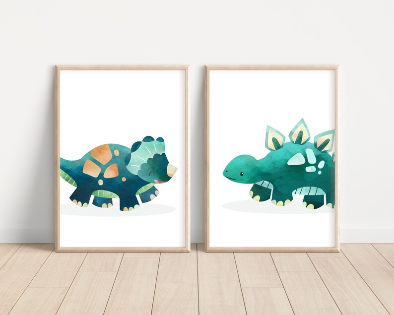 May include: Two framed watercolor illustrations of dinosaurs. The first illustration features a blue and green triceratops. The second illustration features a blue and green stegosaurus.