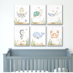 May include: Set of six watercolor illustrations featuring various sea creatures, including an octopus, turtle, stingray, seahorse, whale, and crab. Each illustration is framed with a white border and set against a white background.