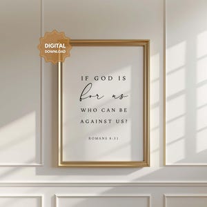 May include: A printable wall art print with a gold frame and a white background. The print features a black and white quote: "If God is for us, who can be against us?" Romans 8:31.