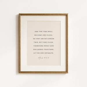 May include: A framed wall art print featuring a beige background with black serif text that reads: AND THE TWO WILL BECOME ONE FLESH. SO THEY ARE NO LONGER TWO, BUT ONE FLESH. THEREFORE WHAT GOD HAS JOINED TOGETHER, LET NO ONE SEPARATE. Mark 10:8-9.