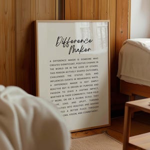May include: A black and white printable poster with the text "Difference Maker" and a definition of what a difference maker is. The poster has a white background and black text.