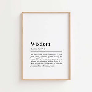 May include: A framed print with the word "Wisdom" in a bold, black font. Below the title is the text "[James] 3:17-18" and a quote about wisdom. The frame is a light brown color, and the background is white.