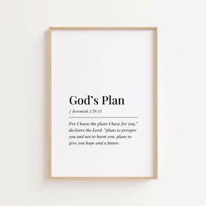 May include: A framed print featuring the words "God's Plan" in black, minimalist font. The print includes the Bible verse Jeremiah 29:11 and a quote about hope and the future. The frame is a light wood colour.