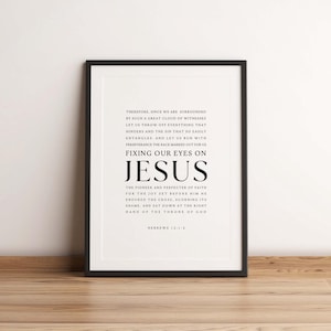 May include: Black and white printable wall art with a quote from Hebrews 12:1-2. The quote reads "Therefore, since we are surrounded by such a great cloud of witnesses let us throw off everything that hinders and the sin that so easily entangles. And let us run with perseverance the race marked out for us fixing our eyes on Jesus the pioneer and perfecter of faith for the joy set before him he endured the cross, scorning its shame, and sat down at the right hand of the throne of God Hebrews 12:1-2"