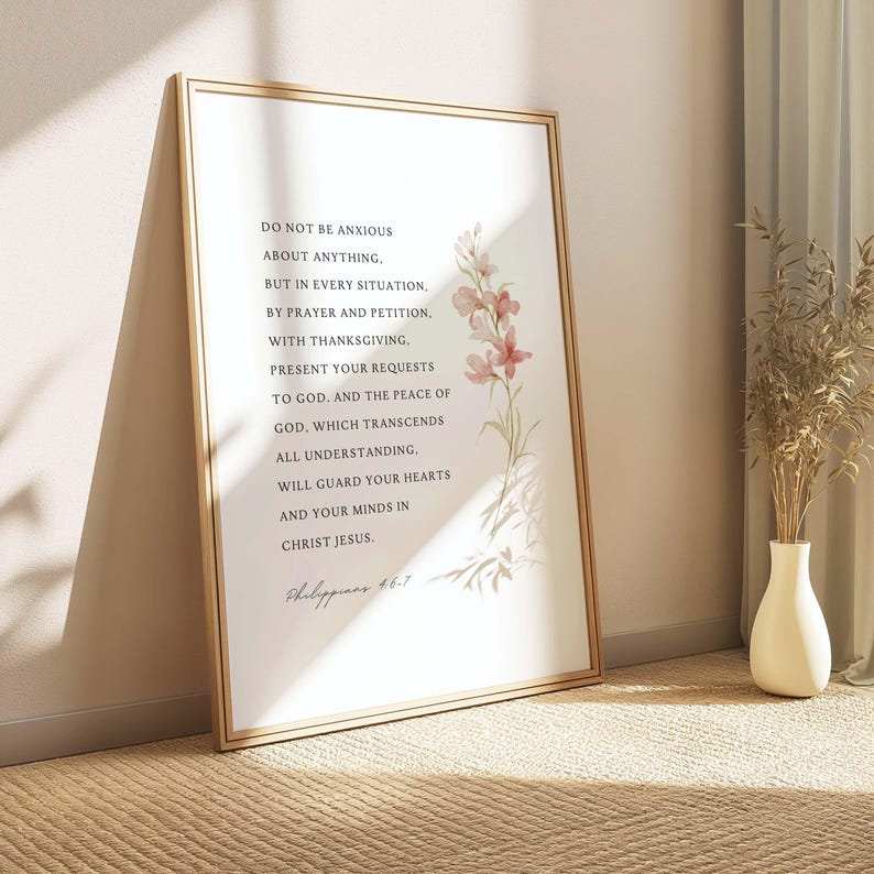 May include: A white printable art print with a gold frame featuring a floral design and a quote from Philippians 4:6-7. The quote reads: "Do not be anxious about anything, but in every situation, by prayer and petition, with thanksgiving, present your requests to God. And the peace of God, which transcends all understanding, will guard your hearts and your minds in Christ Jesus."