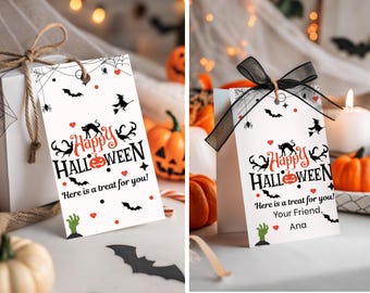 May include: White gift tags with a Halloween theme. The tags feature the words "Happy Halloween" in black and orange, along with bats, spiders, and a witch. The text "Here is a treat for you!" is also included.