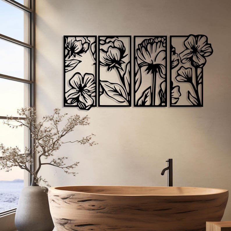 May include: Black metal floral wall art composed of four rectangular panels. Each panel features a different stylized flower design with leaves and stems. The artwork is mounted on a neutral-colored wall, with a wooden bathtub and a window in the background.