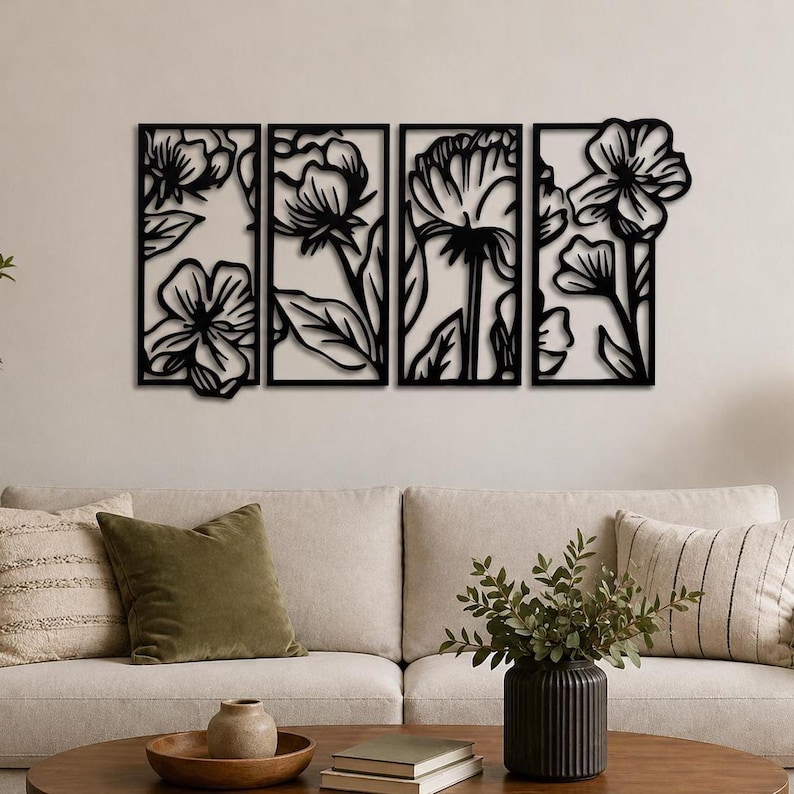 May include: Four-panel black metal floral wall art. Each panel features a different flower design with leaves, creating a cohesive botanical theme. The artwork is mounted on a neutral-colored wall above a sofa.