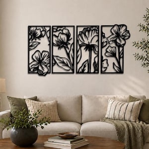 May include: Four-panel black metal wall art featuring floral designs. Each panel showcases a different flower, with intricate cut-out details. The artwork is mounted on a neutral-colored wall, creating a striking contrast. The overall theme is nature and home decor.