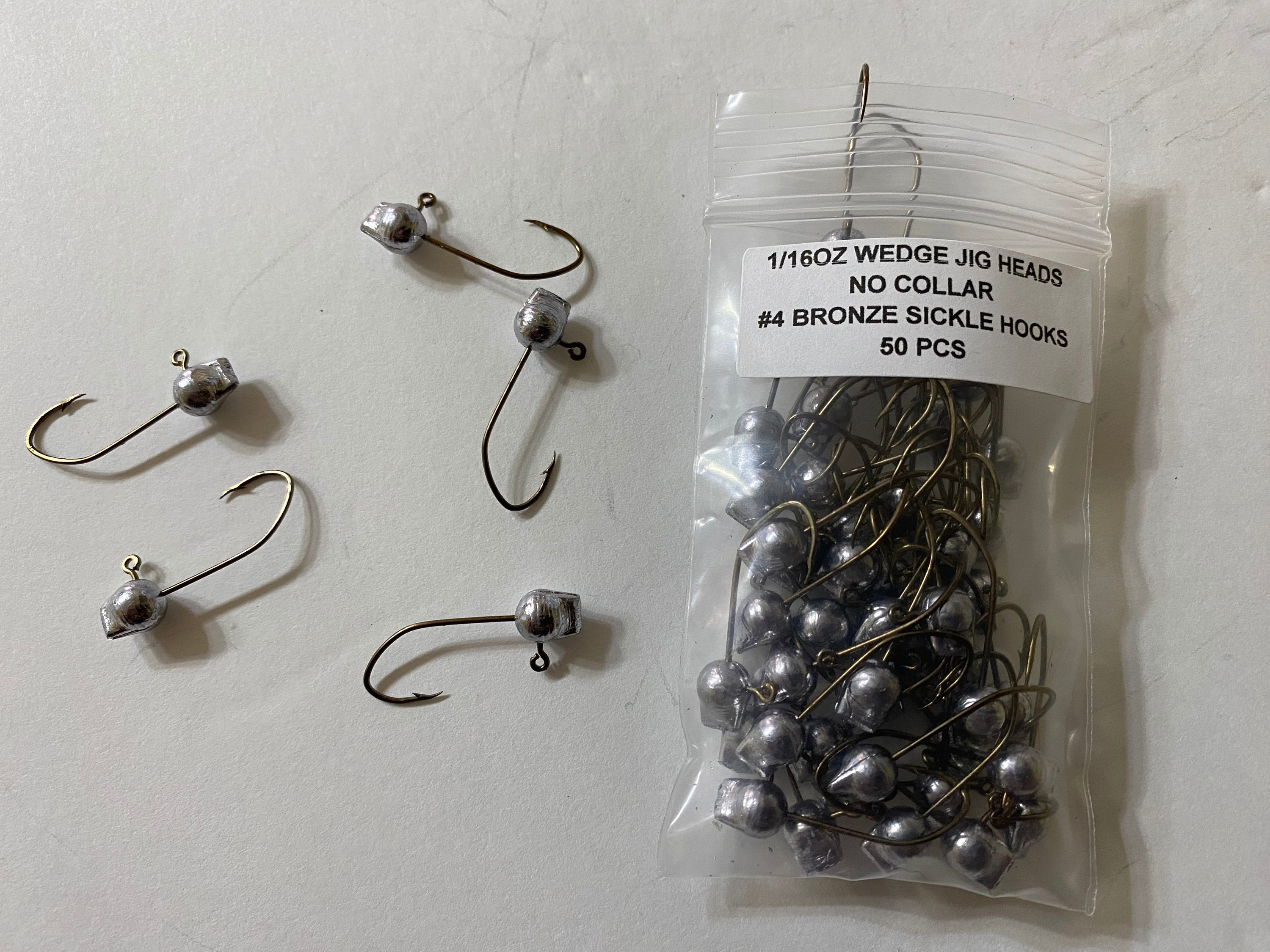 50 Pcs Unpainted 1/16oz Wedge Head Jigs With No Collar and a 4 Bronze  Sickle Hooks 