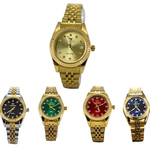 May include: Five gold-toned wristwatches with various colored faces: black, green, red, and blue. The watches have gold bands and bezels, with some featuring diamond-like accents. The watch faces display the brand name and other text.