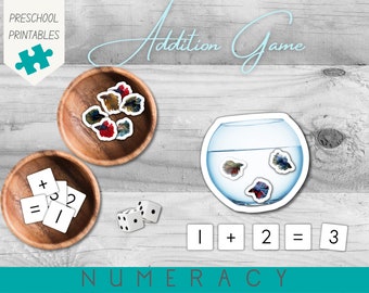 May include: A preschool addition game with colourful fish counters, dice, and number cards. The game includes the words "Addition Game" and "NUMERACY".