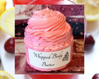 May include: A pink whipped body butter in a clear jar with a white label that reads "Whipped Body Butter".