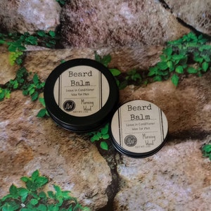 May include: Two small round tins of beard balm, both labeled "Beard Balm Leave in Conditioner Wax for Men Morning Wood Net Wt. 1 oz."