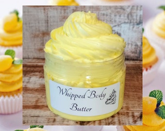 May include: A yellow whipped body butter in a clear jar with a white label that says "Whipped Body Butter".