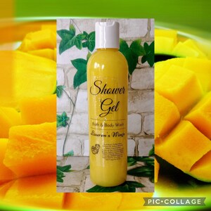 May include: A yellow bottle of shower gel with the words "Shower Gel" and "Bath & Body Wash" printed on the front. The label also includes the text "Lauren's Wings" and a list of ingredients. The bottle is sitting on a background of sliced mango.