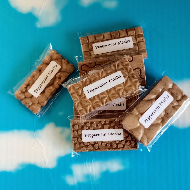 May include: Five individually wrapped bars of Peppermint Mocha flavored chocolate. Each bar has a different design and is wrapped in clear plastic.