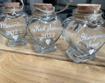 Honeymoon wedding sand. Sweet heart shaped glass bottle jar with a cork. Hand finished with twine and a seashell Personalisation available