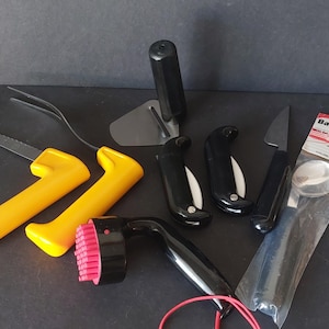 May include: A set of three ceramic mugs with a speckled, matte finish. The mugs are in shades of cream, light gray, and dark gray. Each mug has a simple, minimalist design, perfect for coffee or tea.