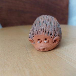 Vintage Ceramic figurine of a cute hedgehog with sad eyes.Handmade.