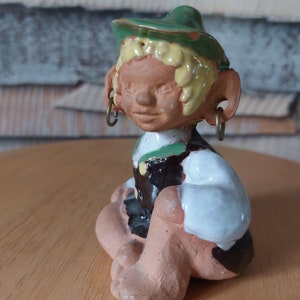 Tomar,Ceramic figurine of a boy in a green hat.Sweden