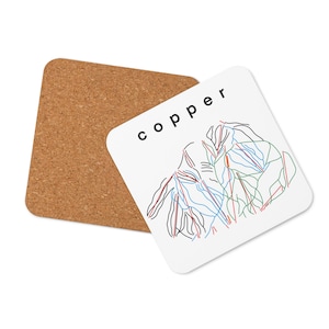 May include: A white coaster with a black and white illustration of a ski resort map. The text "copper" is printed in black at the top of the coaster.