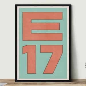 May include: A framed print with a teal background and a large, coral-coloured letter "E" and the number "17" in a bold, sans-serif font.