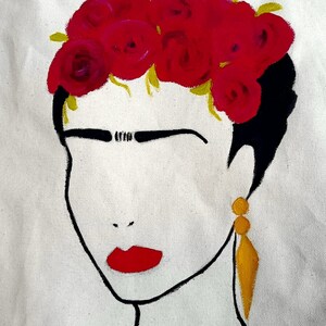 May include: A painting of a woman with a red rose crown, black hair, and a yellow necklace. The woman has a red lip and a gold earring.