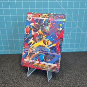 May include: A holographic Mega Lucario EX Pokémon trading card, featuring a dynamic illustration of the character in action. The card displays the text "Fighting Pulse" and "190" with other game details.