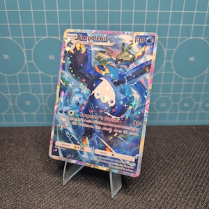 May include: A holographic Empoleon Pokémon card, featuring a blue and white aquatic creature with a crown. The card displays the text "Empoleon", "Emperor's Strike", and "HP 130". The card is propped up on a clear plastic stand.
