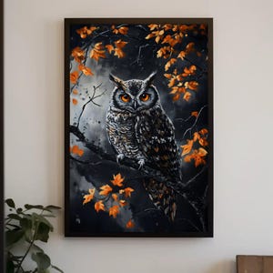 May include: A black and white owl with orange eyes perched on a branch with orange leaves. The owl is looking directly at the viewer. The background is dark and blurry.