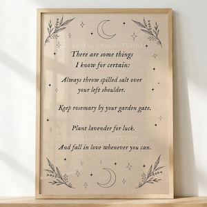 May include: A framed wall art print on beige paper featuring black text that reads: There are some things I know for certain: Always throw spilled salt over your left shoulder. Keep rosemary by your garden gate. Plant lavender for luck. And fall in love whenever you can. The design includes black line art of moons, stars, and leafy branches.