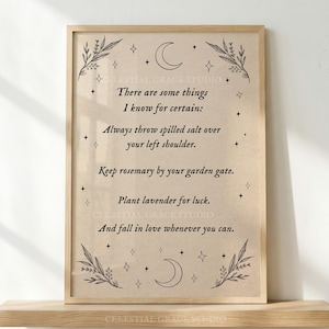 May include: A framed wall art print on beige paper featuring black text that reads: There are some things I know for certain: Always throw spilled salt over your left shoulder. Keep rosemary by your garden gate. Plant lavender for luck. And fall in love whenever you can. The design includes black line art of moons, stars, and leafy branches.