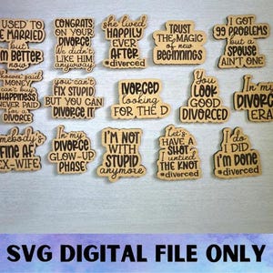 May include: A selection of wooden cutouts with witty sayings about divorce. The cutouts feature black text on a light brown wood. Phrases include "I'm not with stupid anymore" and "Let's have a shot, I untied the knot."