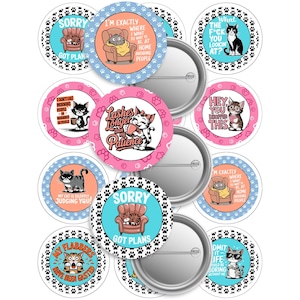 May include: A collection of round pinback buttons with cat-themed designs and humorous text. The buttons feature various cat illustrations, surrounded by paw prints, and phrases like "Sorry, Got Plans" and "I'm Exactly Where I Want to Be."