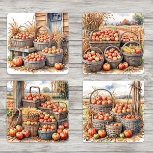May include: Four sets of coasters featuring a watercolour illustration of baskets filled with red and green apples, pumpkins, and wheat stalks. The coasters are perfect for adding a touch of autumn charm to your home decor.
