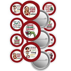 May include: A selection of festive pin badges with red and white designs. The badges display Christmas-themed illustrations and humorous phrases, such as "Drink Drank Drunk!" and a woman in a Santa hat with text.