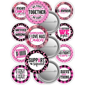 May include: A collection of round, pink and black cancer awareness pins with various text designs. The pins feature phrases like "Fight Cancer," "We Fight Together," and "Support Squad." Each pin has a metal backing.