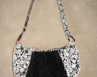 Black and white shoulder bag made from various materials