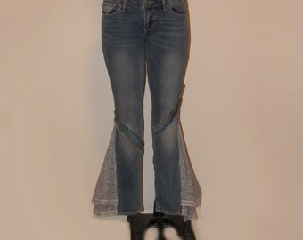 May include: Blue denim jeans with lace trim at the bottom of the legs. The jeans have a straight leg fit and a flared bottom.
