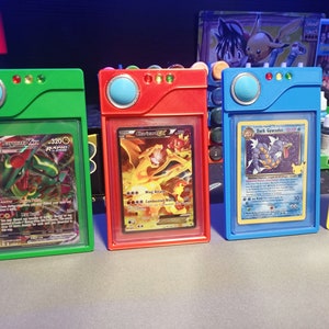 May include: Four colorful plastic card holders with different Pokemon cards inside. The holders are green, red, blue, and yellow. The cards are "Sceptile-EX", "Charizard-EX", "Dark Gyrados", and "Mewtwo-EX".